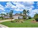 Charming single-story home with a two-car garage, lush landscaping, and a brick-paved driveway on a sunny day at 17725 Northwood Pl., Bradenton, FL 34202