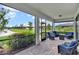 Screened lanai features comfortable seating and views of a pond and landscaped backyard at 17725 Northwood Pl., Bradenton, FL 34202
