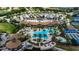 Resort-style pool area with palm trees, ample seating, and a covered outdoor dining space for entertaining at 17725 Northwood Pl., Bradenton, FL 34202