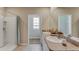 Elegant bathroom featuring double sinks, granite countertops, and a separate shower at 18204 Wheathouse Pl, Lakewood Ranch, FL 34211