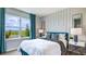 Comfortable bedroom with neutral tones, accent wall, and large window with a pleasant view at 18303 Wheathouse Pl, Lakewood Ranch, FL 34211