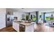 Bright kitchen with stainless steel appliances, an island with seating and a view of the backyard at 18303 Wheathouse Pl, Lakewood Ranch, FL 34211