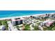 Stunning aerial view showcases beachfront condos with vibrant landscaping and easy beach access at 1945 Gulf Of Mexico Dr # M2-313, Longboat Key, FL 34228