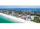 Aerial view showcasing beachfront condos near a pool, parking area, and ocean at 1945 Gulf Of Mexico Dr # M2-313, Longboat Key, FL 34228