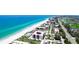 Aerial view of beachfront condos with a pool, surrounded by lush landscaping and the ocean at 1945 Gulf Of Mexico Dr # M2-313, Longboat Key, FL 34228