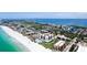 Aerial view highlighting beachfront condos with a pool, golf course, and bay views at 1945 Gulf Of Mexico Dr # M2-313, Longboat Key, FL 34228