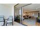 Balcony with striped lounge chairs and sliding glass doors opening to the condo's combined living spaces at 1945 Gulf Of Mexico Dr # M2-313, Longboat Key, FL 34228