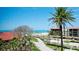 Breathtaking balcony view of pristine beach and lush surroundings, creating a tranquil outdoor retreat at 1945 Gulf Of Mexico Dr # M2-313, Longboat Key, FL 34228