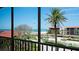 Screened balcony view of tropical landscaping, beach, and ocean at the beachfront condo community at 1945 Gulf Of Mexico Dr # M2-313, Longboat Key, FL 34228