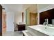 Bright bathroom with modern fixtures, vessel sinks, wood cabinets, and glass enclosed shower at 1945 Gulf Of Mexico Dr # M2-313, Longboat Key, FL 34228