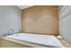 Large white bathtub with modern fixtures and neutral-toned tile surround, offering a relaxing spa-like experience at 1945 Gulf Of Mexico Dr # M2-313, Longboat Key, FL 34228
