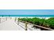 Beautiful beachfront with turquoise water, white sand, beach umbrellas and chairs perfect for a relaxing vacation at 1945 Gulf Of Mexico Dr # M2-313, Longboat Key, FL 34228