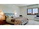 Modern bedroom with a large window, comfortable bed, and minimalist decor at 1945 Gulf Of Mexico Dr # M2-313, Longboat Key, FL 34228