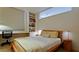 Bright bedroom with large window, built-in shelving, a desk, and a comfortable bed at 1945 Gulf Of Mexico Dr # M2-313, Longboat Key, FL 34228