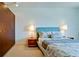 Modern bedroom with a large window, comfortable bed, side tables, and minimalist decor at 1945 Gulf Of Mexico Dr # M2-313, Longboat Key, FL 34228