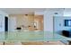Dining area featuring a modern glass table with white chairs and minimalist design at 1945 Gulf Of Mexico Dr # M2-313, Longboat Key, FL 34228