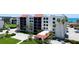 Charming condo building with red tile roofs and lush landscaping, offering a welcoming beachside retreat at 1945 Gulf Of Mexico Dr # M2-313, Longboat Key, FL 34228