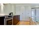 Modern kitchen featuring stainless steel appliances, white countertops, and sleek, minimalist cabinets at 1945 Gulf Of Mexico Dr # M2-313, Longboat Key, FL 34228
