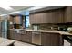 Modern kitchen with stainless steel appliances, tiled backsplash, and beautiful countertops at 1945 Gulf Of Mexico Dr # M2-313, Longboat Key, FL 34228