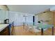 Bright modern kitchen with hardwood floors, modern cabinetry, stainless appliances, and glass dining table at 1945 Gulf Of Mexico Dr # M2-313, Longboat Key, FL 34228