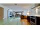 Open concept kitchen and living area, featuring stainless steel appliances and view to balcony at 1945 Gulf Of Mexico Dr # M2-313, Longboat Key, FL 34228