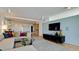 Comfortable living room with a modern sofa, hardwood floors, and wall-mounted TV at 1945 Gulf Of Mexico Dr # M2-313, Longboat Key, FL 34228
