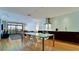 Open concept living and dining area with hardwood floors, view to balcony, and modern kitchen at 1945 Gulf Of Mexico Dr # M2-313, Longboat Key, FL 34228