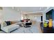 View of open concept living room with hardwood floors and a comfortable sofa next to modern kitchen at 1945 Gulf Of Mexico Dr # M2-313, Longboat Key, FL 34228
