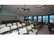 Bright meeting room with ocean views, ample seating, and modern lighting fixtures at 1945 Gulf Of Mexico Dr # M2-313, Longboat Key, FL 34228