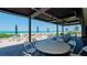 Beachside patio with outdoor seating, tables, chairs and a stunning view of the beach and the ocean at 1945 Gulf Of Mexico Dr # M2-313, Longboat Key, FL 34228