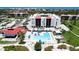 Relaxing community pool area with lounge chairs, tables, umbrellas, and well-maintained landscaping at 1945 Gulf Of Mexico Dr # M2-313, Longboat Key, FL 34228