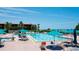 Community pool area with chairs, tables, umbrellas, and beach access at 1945 Gulf Of Mexico Dr # M2-313, Longboat Key, FL 34228