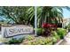 Welcoming SEAPLACE sign with vibrant flowers, tropical plants, and lush greenery at 1945 Gulf Of Mexico Dr # M2-313, Longboat Key, FL 34228