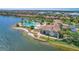 Aerial view showcases the community's luxurious amenities: lakefront access, swimming pool, and clubhouse for a resort lifestyle at 197 Villoresi Blvd, Nokomis, FL 34275