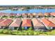 Aerial view of the neighborhood showing water view, lush grass, and mature landscaping at 197 Villoresi Blvd, Nokomis, FL 34275