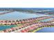 Aerial view of a community nestled by a lake and water canals with terra cotta roofs at 197 Villoresi Blvd, Nokomis, FL 34275