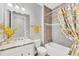 Well-lit bathroom featuring a vanity, mirror, toilet, and shower with a decorative curtain at 197 Villoresi Blvd, Nokomis, FL 34275