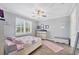 Comfortable bedroom features wood-look tile flooring, a ceiling fan, and a window with bright natural light at 197 Villoresi Blvd, Nokomis, FL 34275