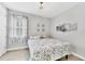Bedroom with light walls, tile floor, a floral bedspread and a view to the outside at 197 Villoresi Blvd, Nokomis, FL 34275