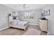 Cozy bedroom features a ceiling fan, a window, and a clean design with wood-look tile flooring at 197 Villoresi Blvd, Nokomis, FL 34275