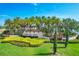 Beautiful Toscana Isles community entrance sign with lush landscaping, palm trees and green grass under a clear blue sky at 197 Villoresi Blvd, Nokomis, FL 34275