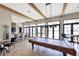 Game room featuring a billiard table, bar area, TV, high ceilings with exposed beams, and natural light at 197 Villoresi Blvd, Nokomis, FL 34275