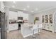 Bright kitchen features stainless steel appliances, granite countertops, and a large island with barstool seating at 197 Villoresi Blvd, Nokomis, FL 34275