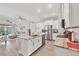 Open concept kitchen with stainless steel appliances and granite countertops flows into the living area at 197 Villoresi Blvd, Nokomis, FL 34275