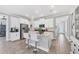 Modern kitchen with white cabinets, stainless steel appliances, and center island with bar stools at 197 Villoresi Blvd, Nokomis, FL 34275