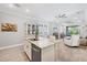 Open concept kitchen has island and breakfast bar, overlooking the living room and patio area at 197 Villoresi Blvd, Nokomis, FL 34275