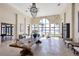 Spacious clubhouse lobby with stone wall, large windows, tiled floors, chandelier, and comfortable seating at 197 Villoresi Blvd, Nokomis, FL 34275