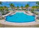 Stunning community pool with lounge chairs and tropical landscaping offering the perfect place to relax and socialize at 197 Villoresi Blvd, Nokomis, FL 34275