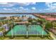 Enjoy a game of tennis on the community's well-maintained courts with lush landscaping and picturesque lake views at 197 Villoresi Blvd, Nokomis, FL 34275