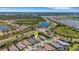 Stunning aerial view of home in a lovely community with serene lakes and lush landscaping at 204 Corelli Dr, Nokomis, FL 34275